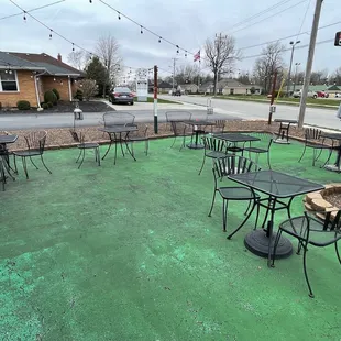 tables and chairs on a green patio