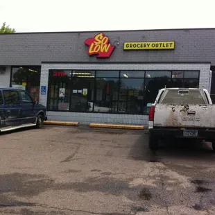 two trucks parked in front of the store