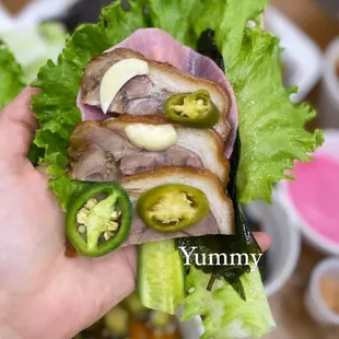 a hand holding a sandwich