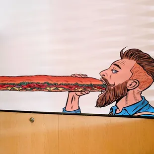 a man eating a large sandwich