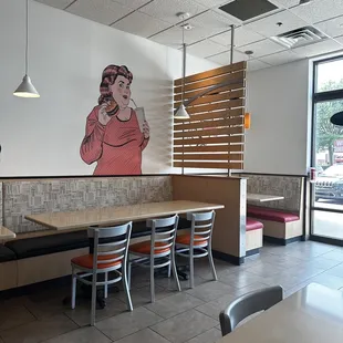 a dining area with tables and chairs