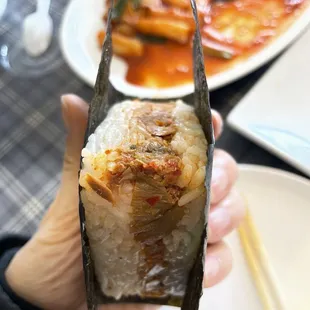 a person holding a piece of food