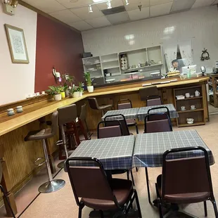 a kitchen with tables and chairs