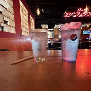 a cold drink and a straw in a glass