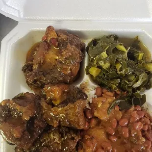 chicken, beans, and greens in a styrofoam container