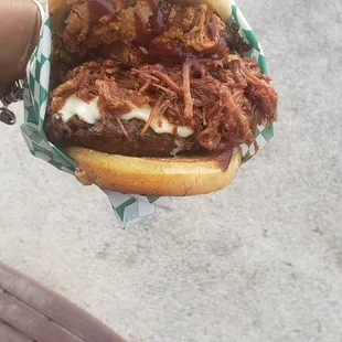 a person holding a sandwich