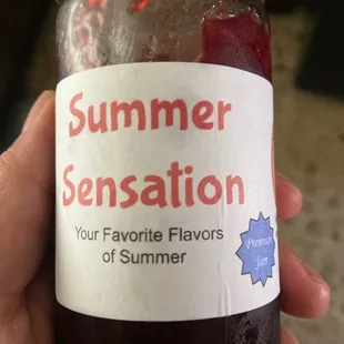 a hand holding a jar of jam