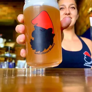 a woman holding a pint of beer