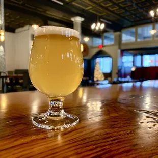 a glass of beer on a bar