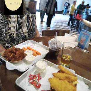 a woman sitting at a table with food