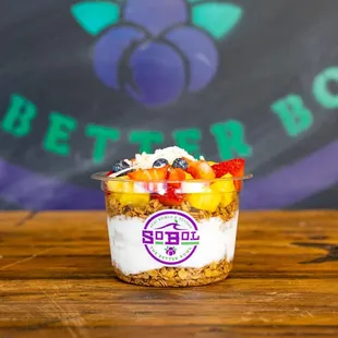 a cup of yogurt with fruit on top