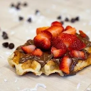 a waffle with chocolate and strawberries