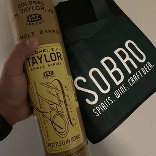 a hand holding a can of soda