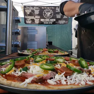 a person preparing a pizza