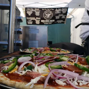 a pizza with onions and peppers