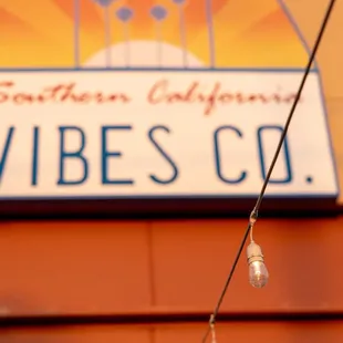 a feather hanging from a wire