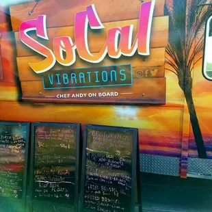 a colorful food truck with menus