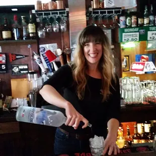 a woman pouring a drink