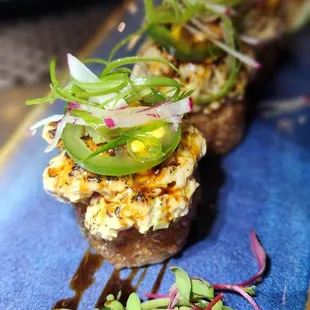 a platter of appetizers on a blue plate