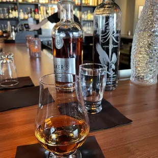 a glass of whiskey on a bar