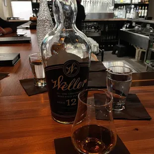 a glass of whiskey and a bottle