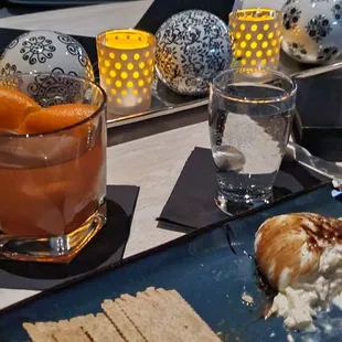 a glass of tea and a plate of crackers