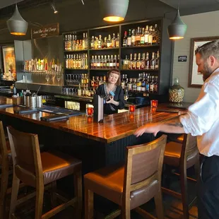 a man and a woman at a bar