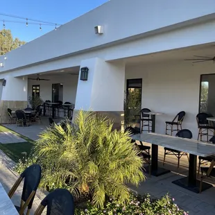 a patio with tables and chairs