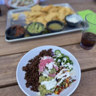 Fiesta bowl with impossible meat instead of shrimp. Chips and salsa flight in the background!