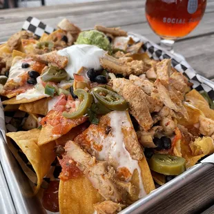 a plate of nachos and a glass of beer
