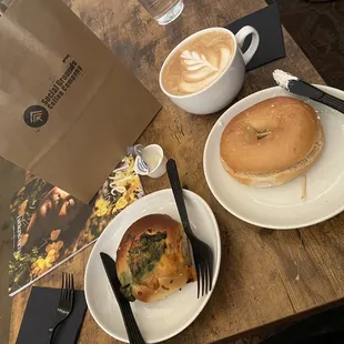 two plates of food and a bagel