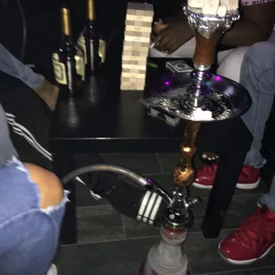 people sitting around a table with a hookah