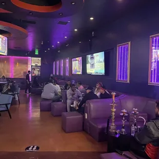 a group of people sitting at a bar