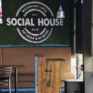a table and chairs in front of a sign