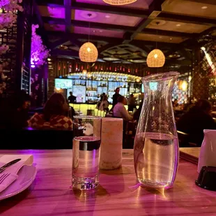 a table with a pitcher of water and a glass of water