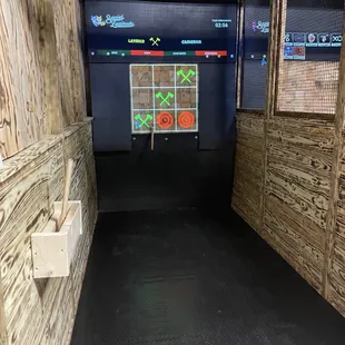 a room with a wooden wall and a black floor