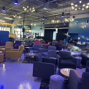 a lounge area with chairs and tables