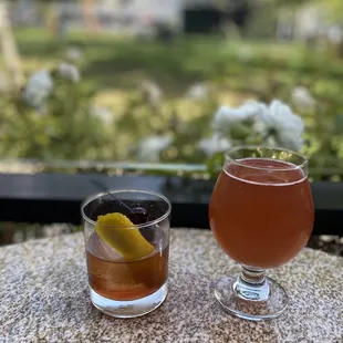 two glasses of alcohol on a table