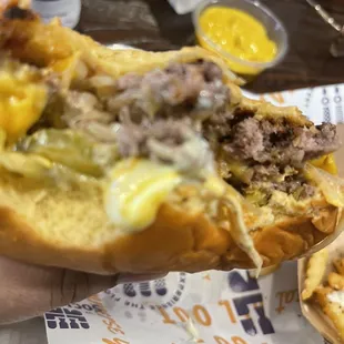 Me admiring my bites into the onion burger