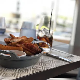 a bowl of french fries on a table