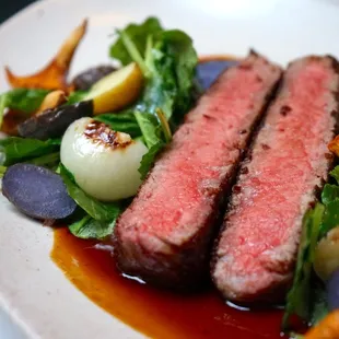 a plate of steak and vegetables