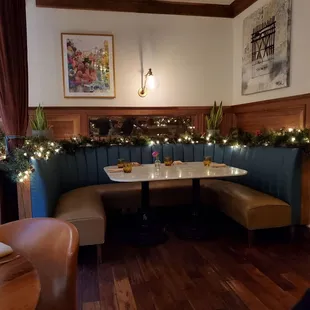 a corner booth with christmas lights