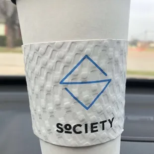 a coffee cup with a sticker on it