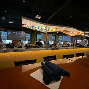 a restaurant with people sitting at the bar