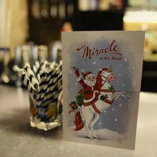 a christmas card and a glass of water