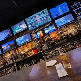 a bar with multiple televisions