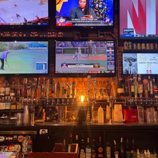 a sports bar with multiple screens