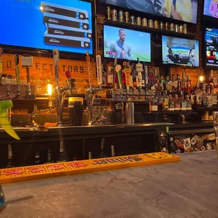 a bar with several televisions