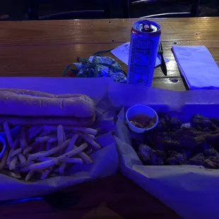 Right: fries and bun, left: bacon and pork with a bud light seltzer