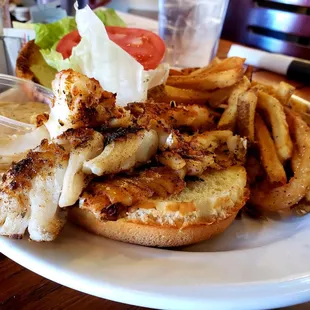Grouper Sandwich- Blackened, topped with lettuce, tomato and tartar sauce on a Brioche bun. Handcut French fries on the side.